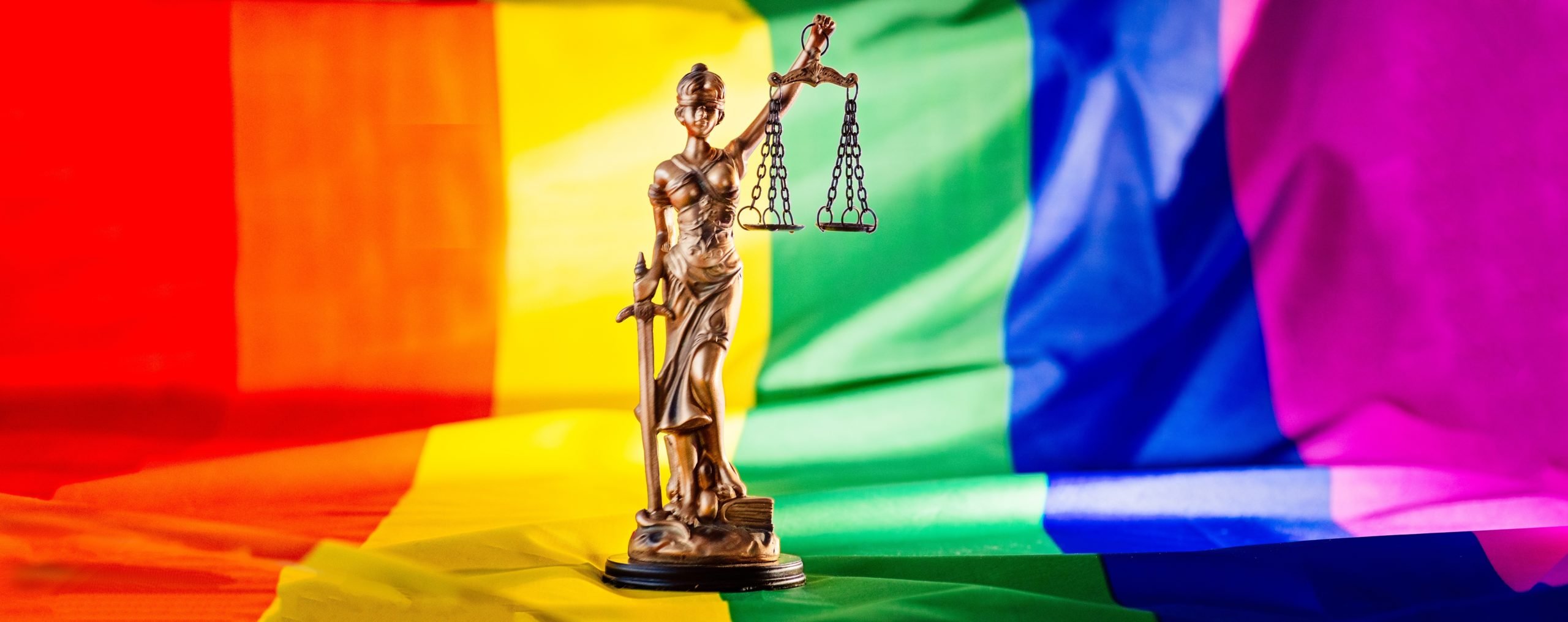 Statue of justice symbol of law and justice with lgbt flag